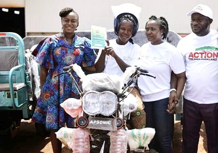 Rosy Fynn (left),  Country Head of MasterCard Foundation, and Aaron Adu (right), MD of GSA, presenting tricycles to the women shea collectors at the launch of the programme